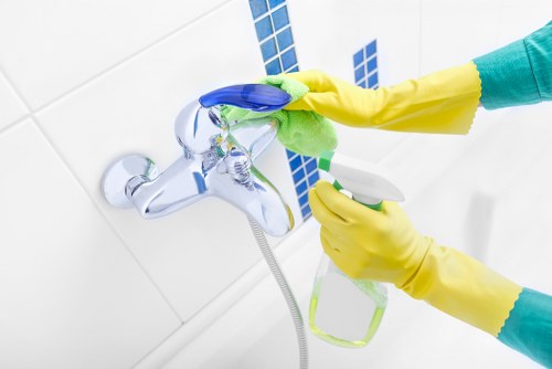 Team member applying safe cleaning procedures in a property